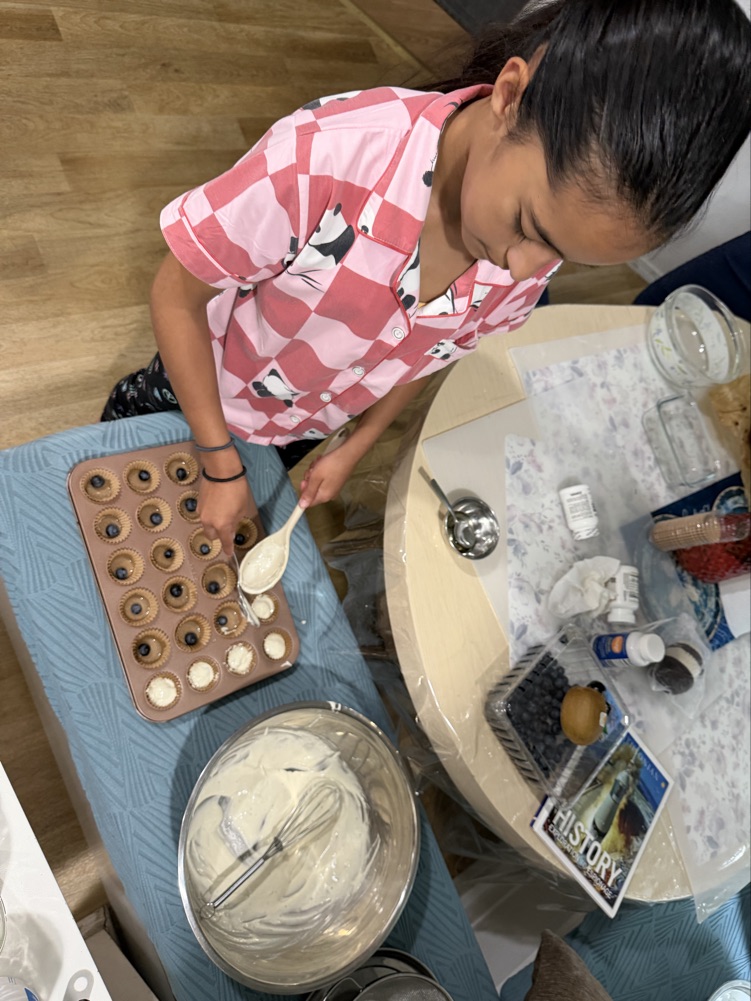 Hanna filling gourmet cake puck molds in her kitchen